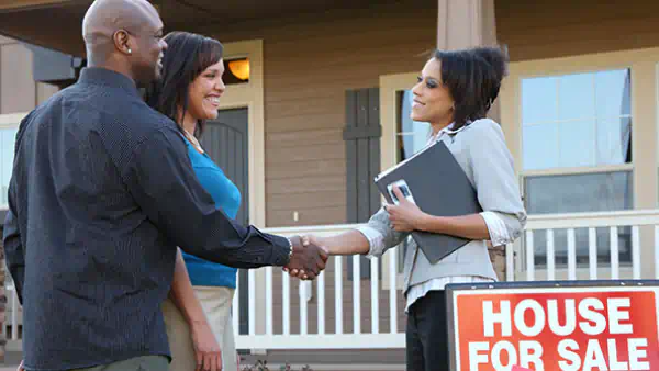 Couple meets a realtor at an open house