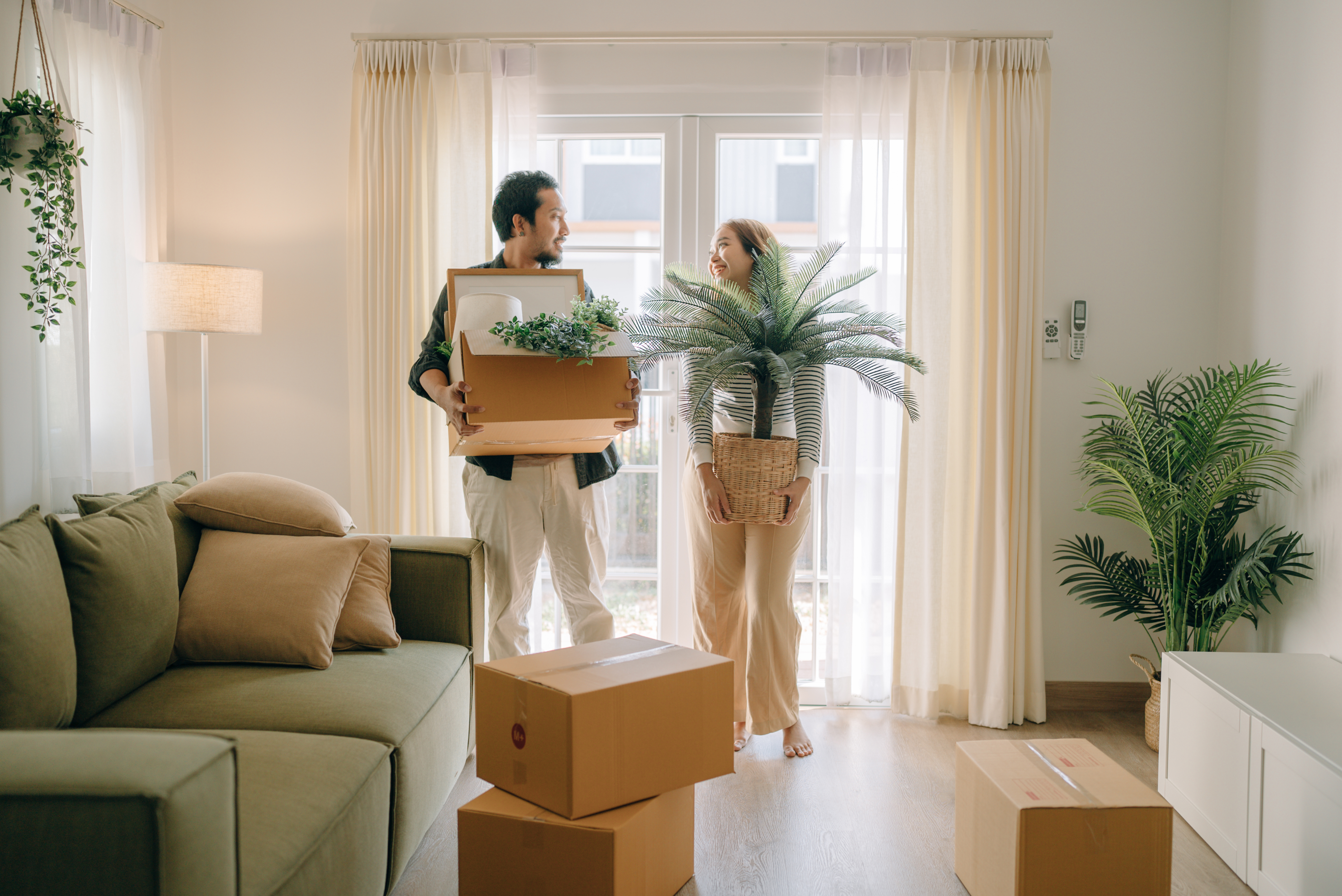 People holding plants in apartment
