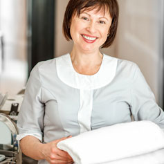 Hotel room service attendant smiling